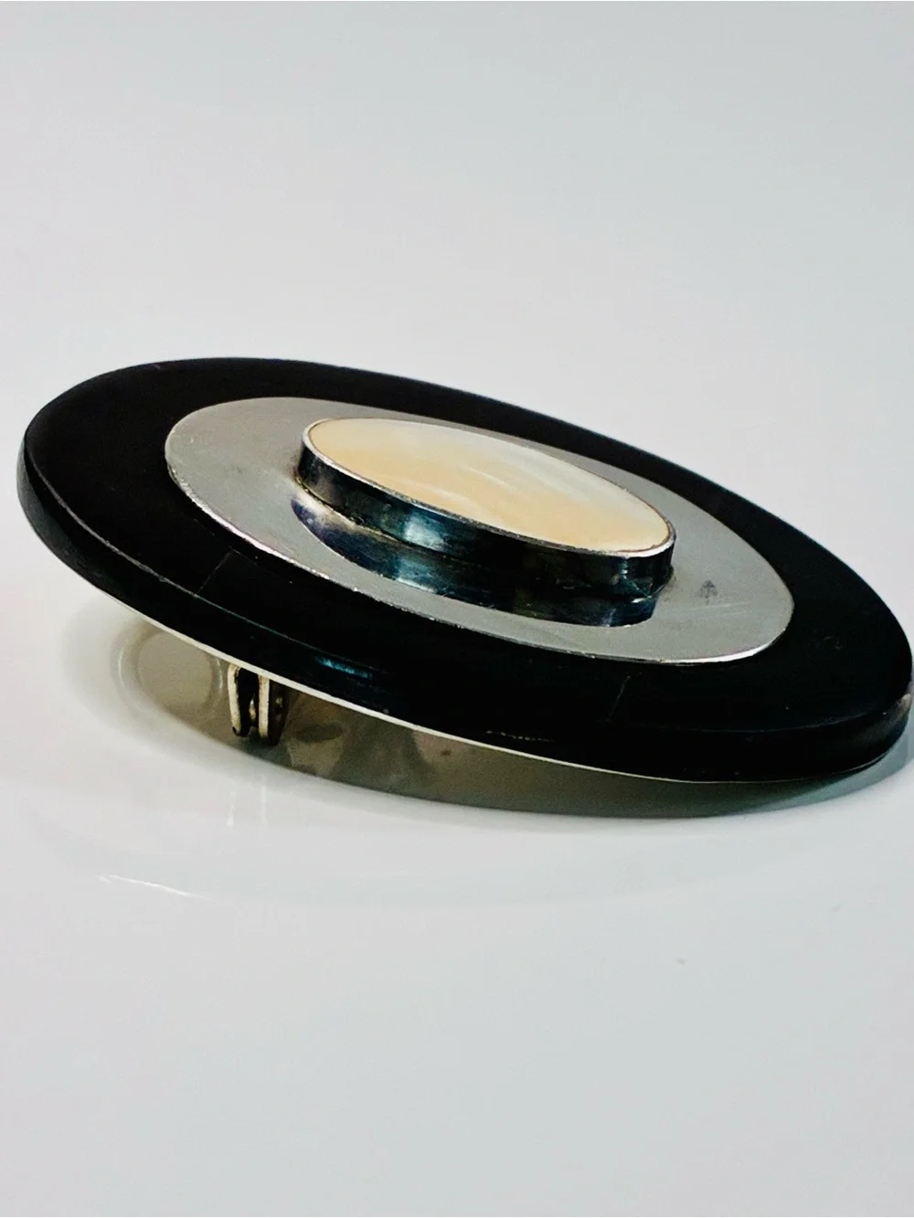 Elevated Simple Black and Silver Oval Brooch with Mother-of-Pearl Center Pendant